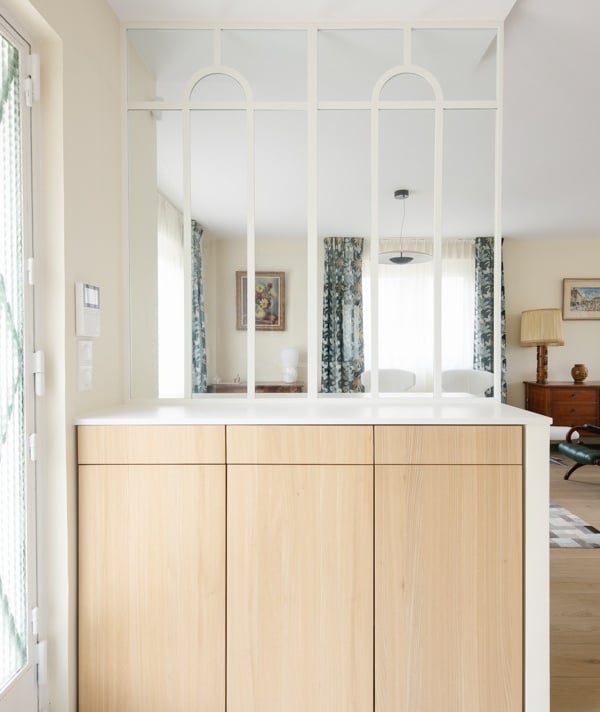a kitchen with a large mirror and a sink