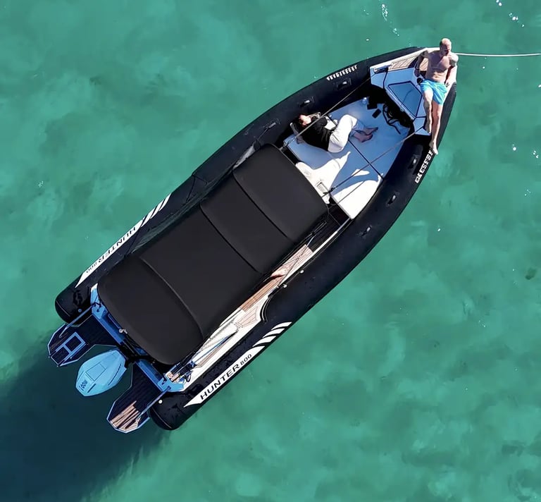 Aerial of Hunter Pro 800 RIB speedboat anchored in Adriatic water with guests on bow sundeck during private tour from Split.