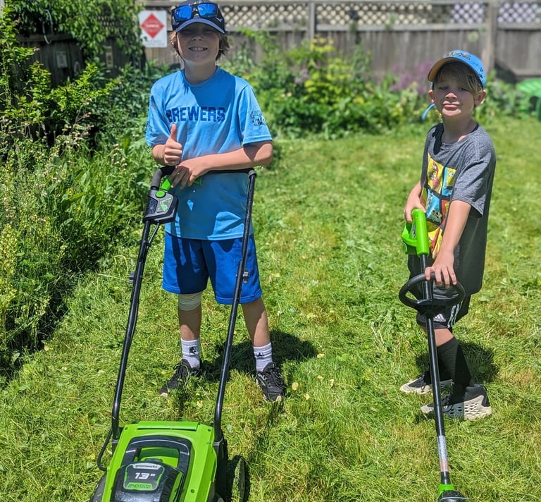 two boys mowing lawns in washington heights