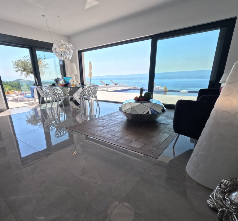 Villa Fay living room with a table and chairs and sea view