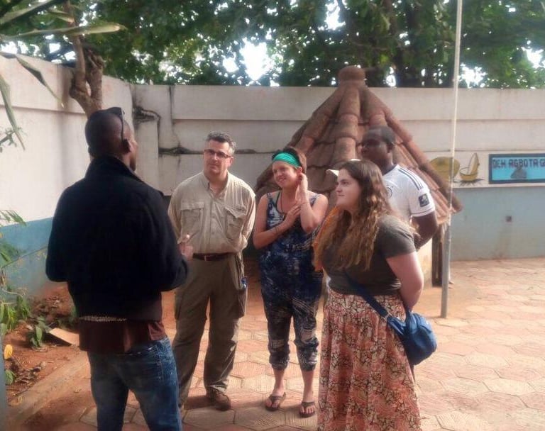 Dahomey African Tours Guide leading tourists in Pythons Temple in Benin