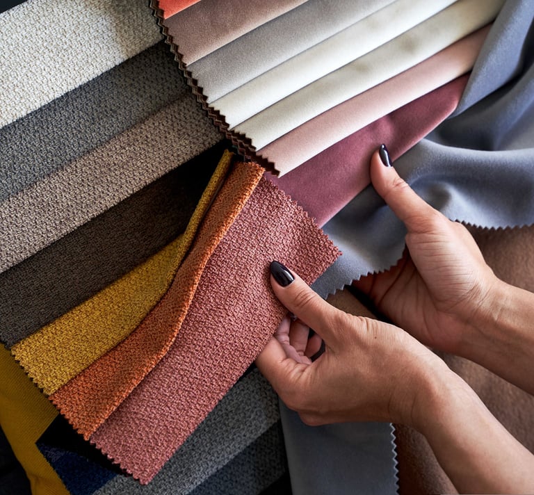 Interior designer Hands checking the quality of textile samples