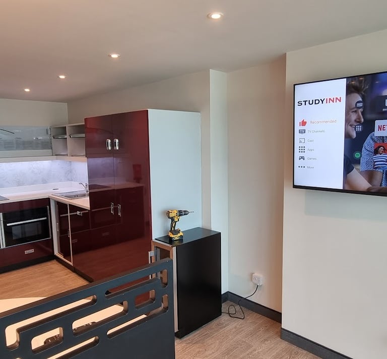 MountMyTV - Samsung 65" TV mounted on a wall in a university communal area