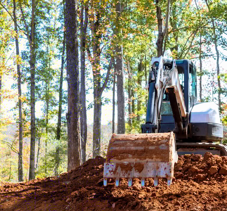 bobcat excavator digging dirt with bucket attachment