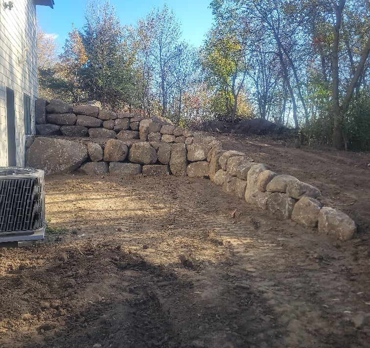 boulder wall next to residential home