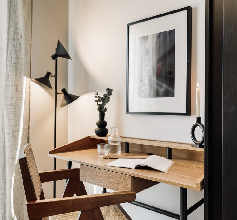 Working area with wood desk and subtle lighting, cozy decor and natural colour palette