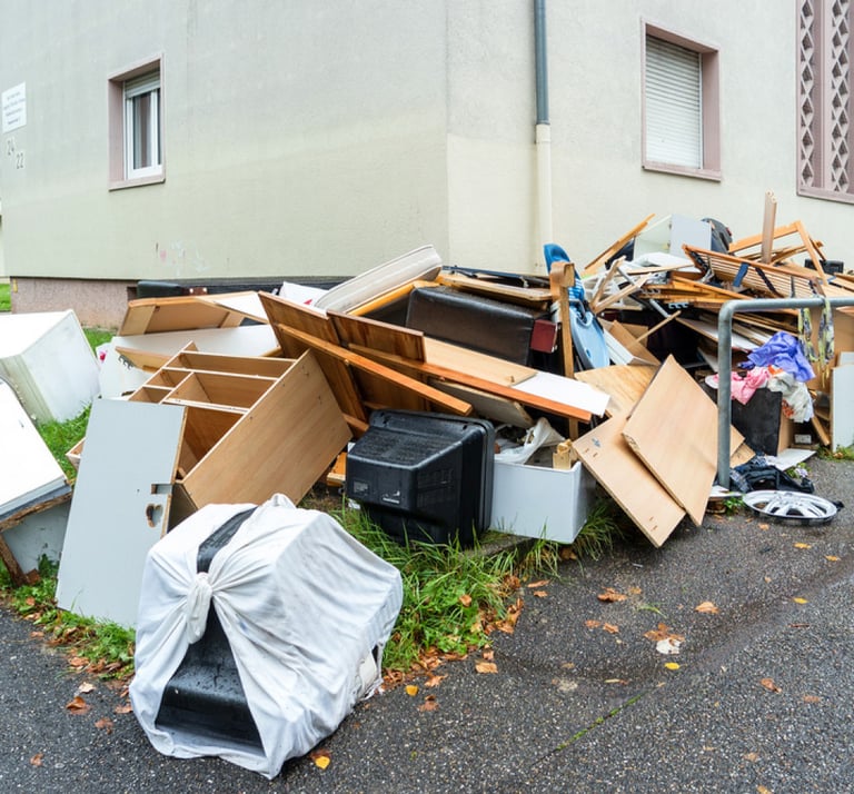 broken furniture piled along driveway