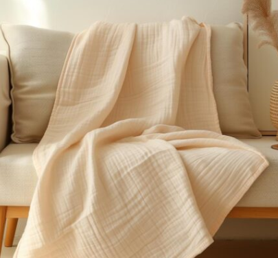 Soft 100% organic cotton muslin blanket in classic ivory by Sleep and Beyond.
