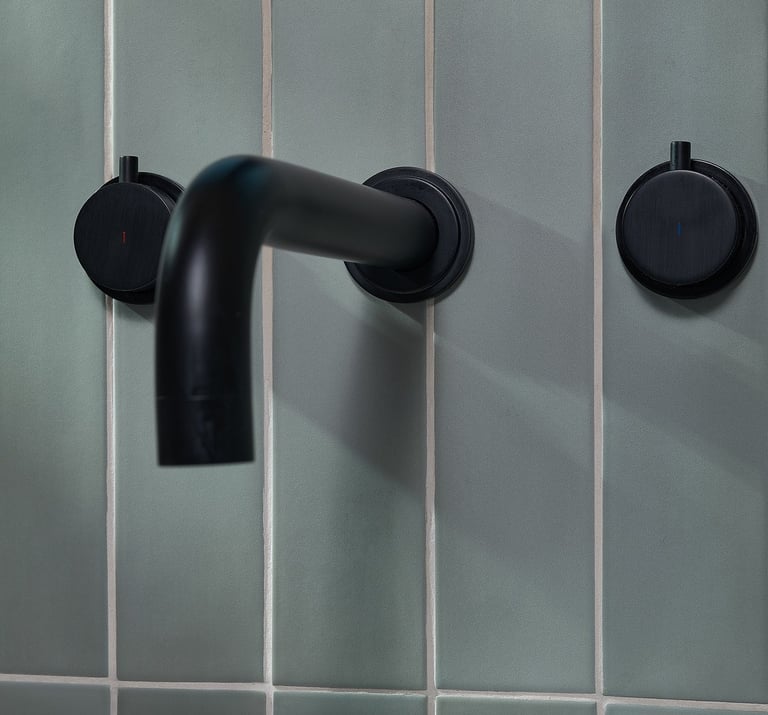 blue vertical tile with white grout and black bath tap 