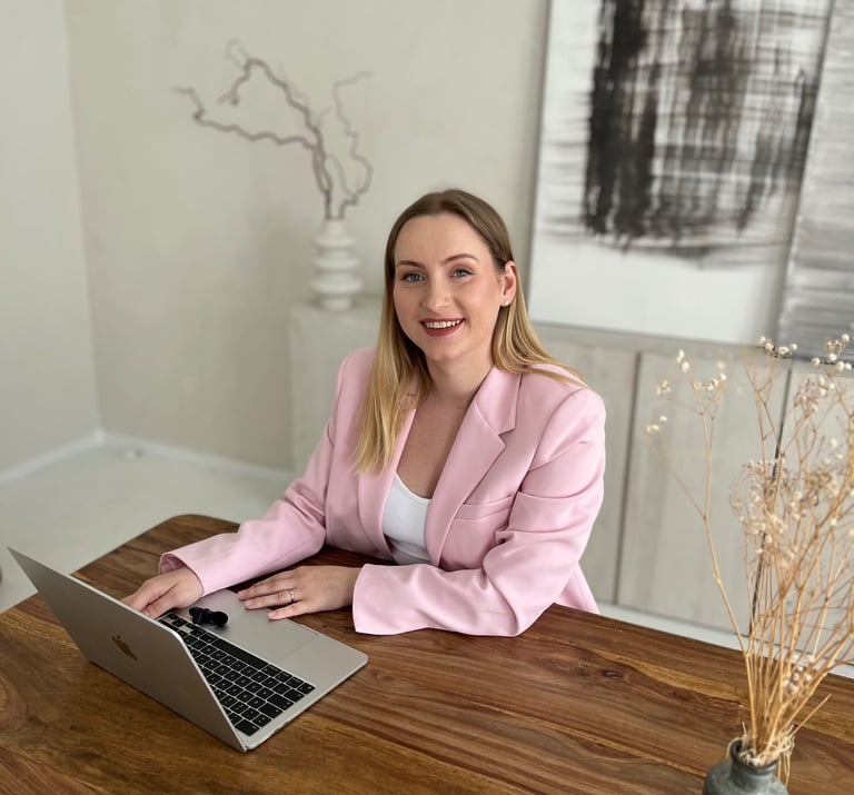 a woman sitting at a table with a laptop