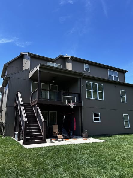 Finished modern exterior paint job with white window trim Blue Springs