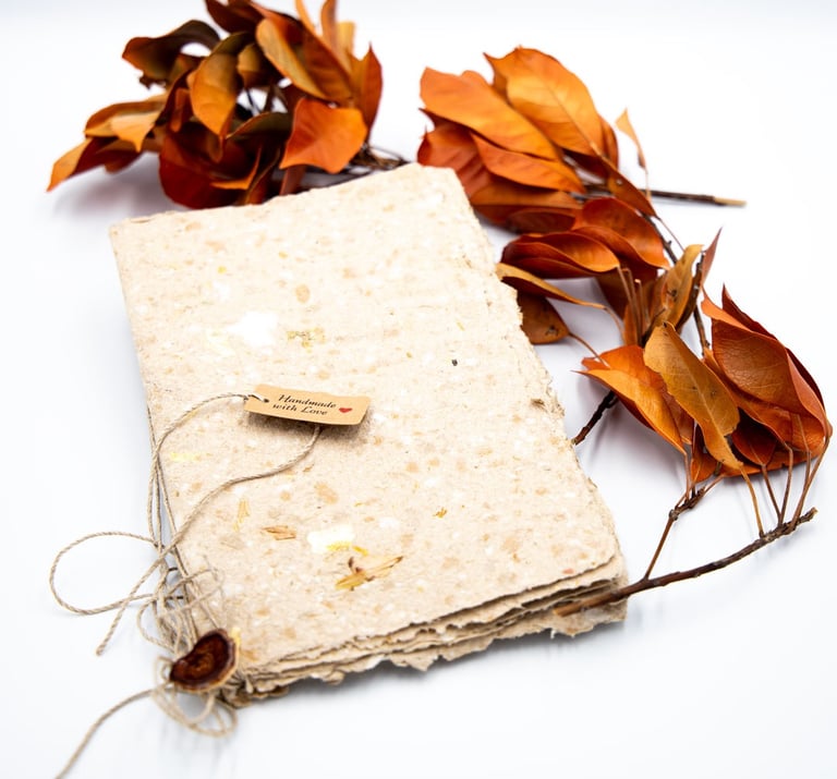 A book of handmade paper with some leaves