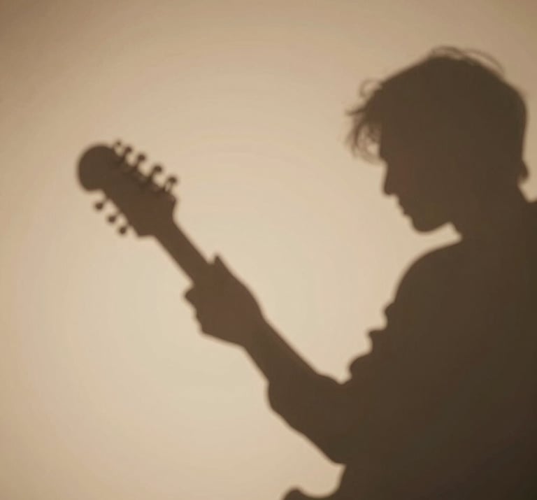 Abstract shadows of a musician playing against a soft almond wall, minimalist and artistic composition, warm inviting atmosphere.