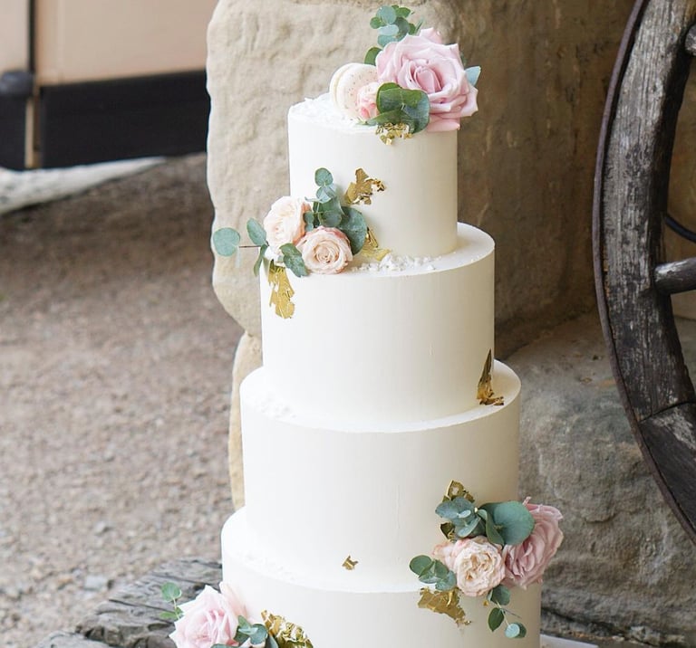 a wedding cake with flowers on top of it