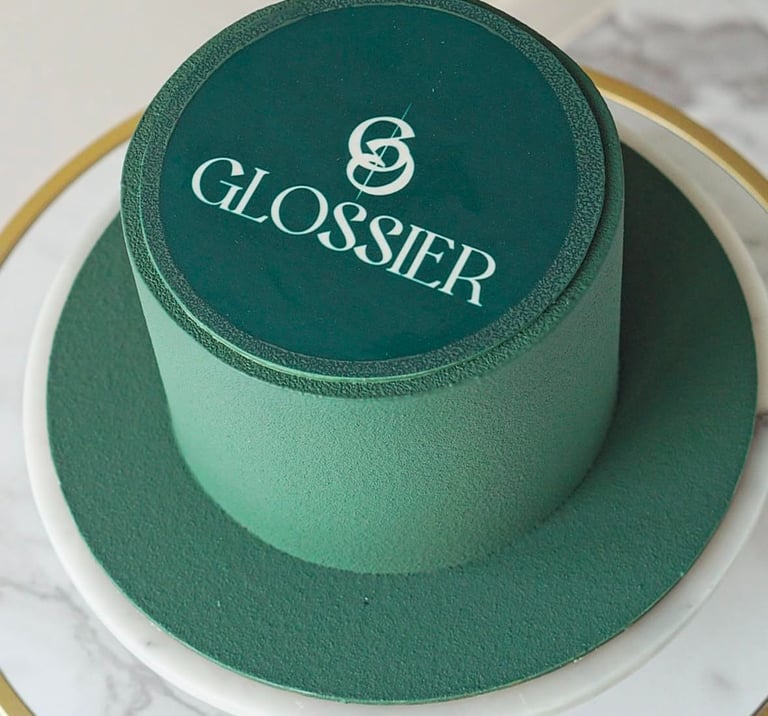 a cake with a green hat on top of a table