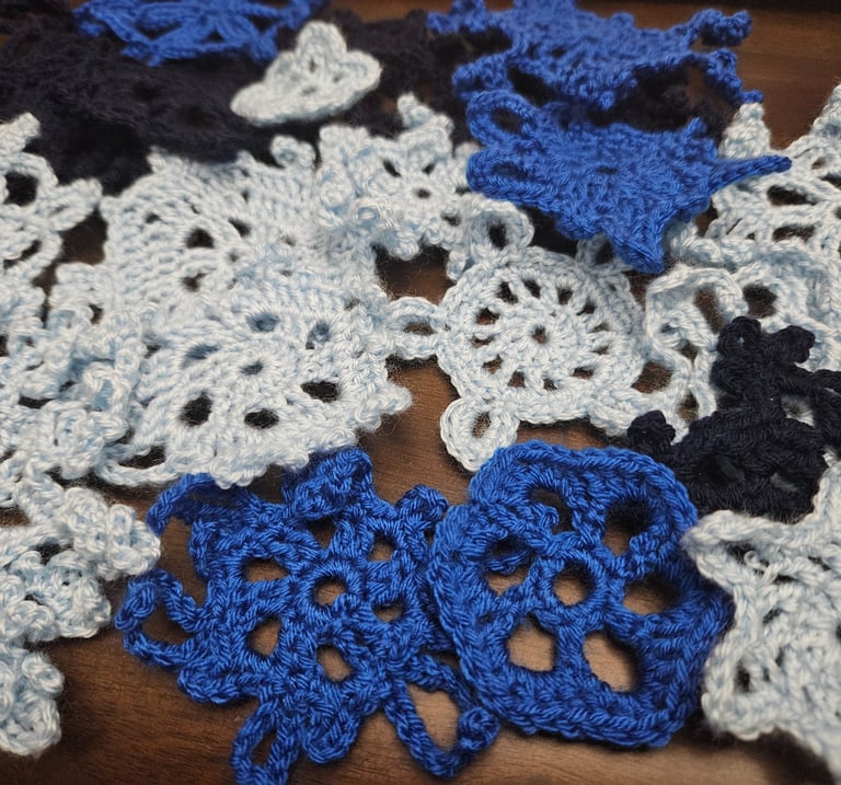 crochet snowflakes on a wooden table
