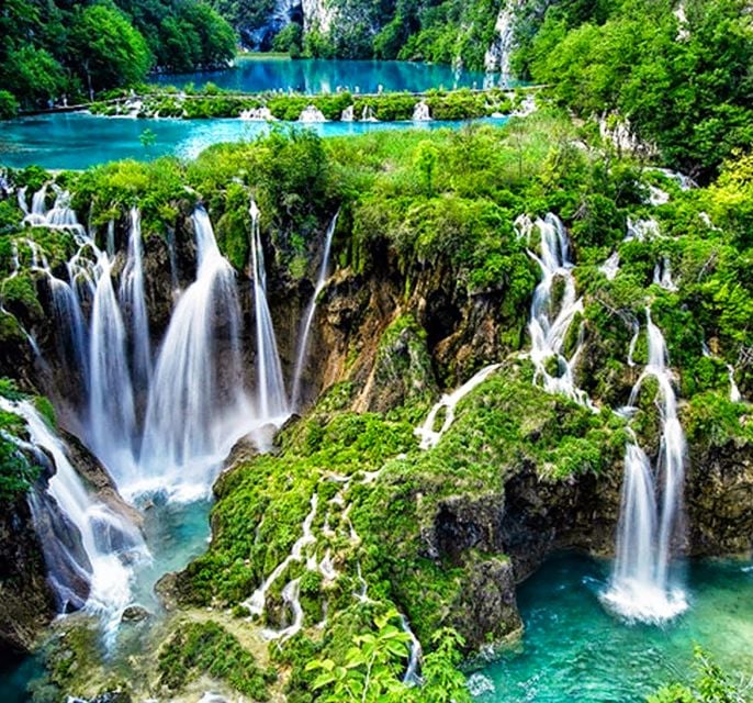 The photo shows amazing nature - a 3 turquoise blue lakes and the amazing waterfalls flowing between them,and greenery around