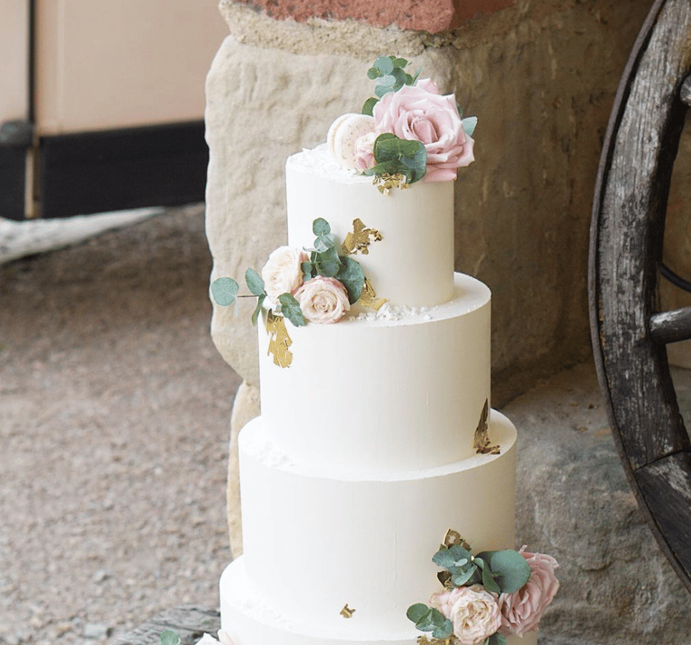 a wedding cake with flowers on top of it