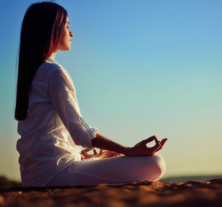 a woman sitting in a meditation position