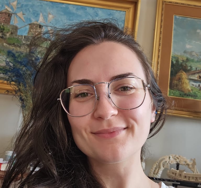 a woman with glasses and a white shirt