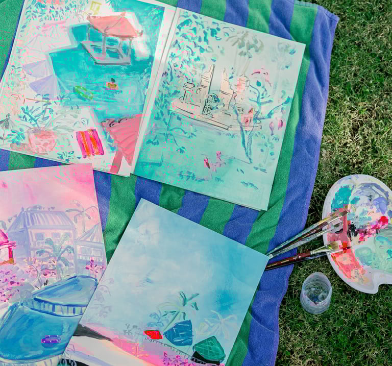 a bunch of paintings on a blanket. Sketchbooks in Bali by artist Lena Sin