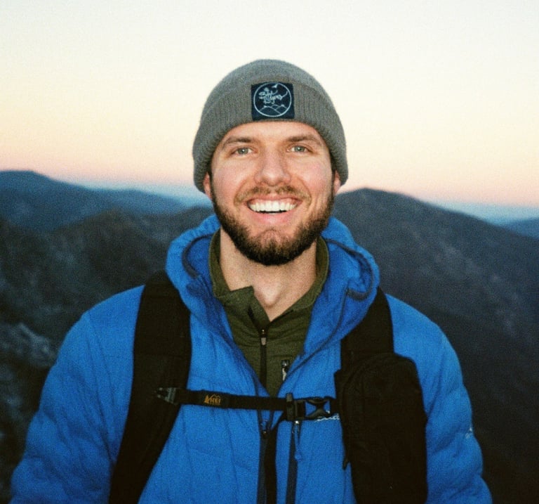 Nate Bowery standing in front of the Great Smoky Mountains during a winter hike