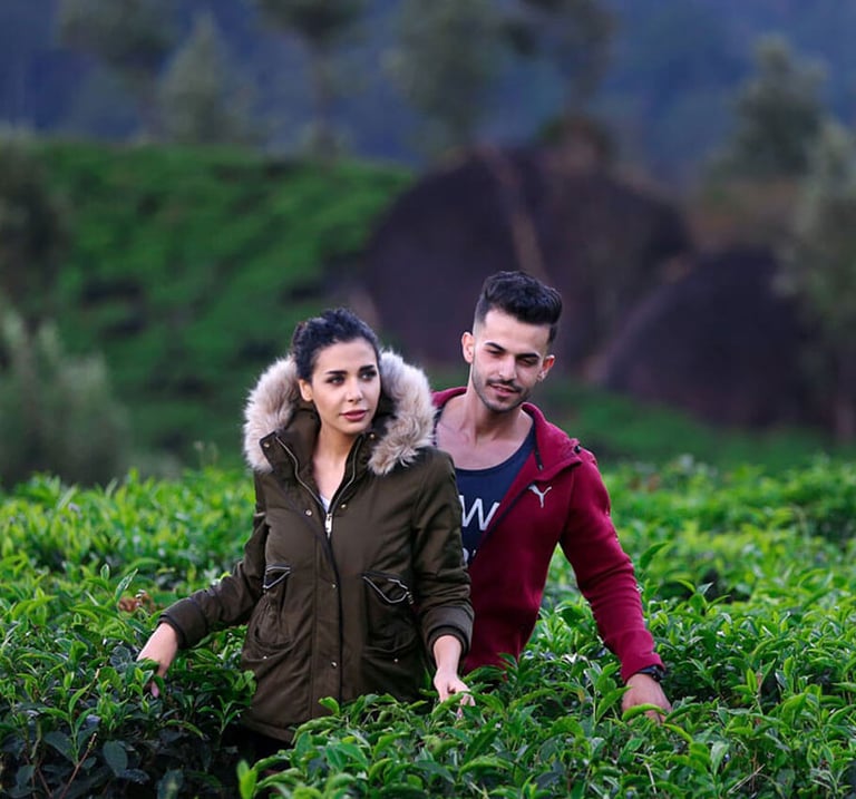A couple wandering around tea plantation near Munnar.