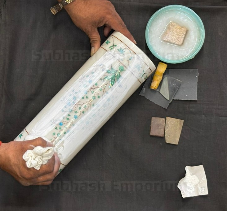 Polishing of a marble article on a black background