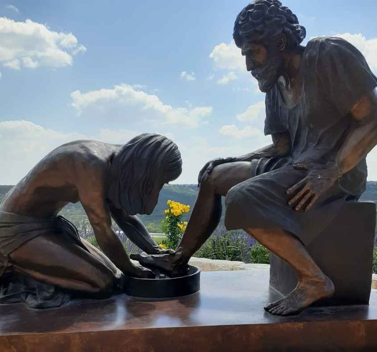 Large bronze sculpture of Jesus washing Peter's feet