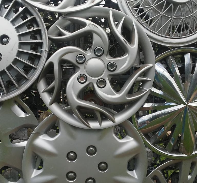 Eight chrome hubcaps welded together.