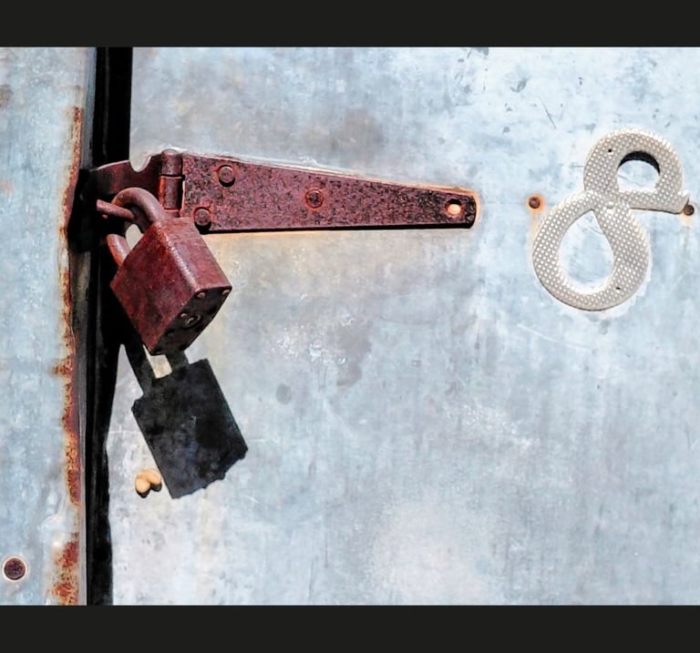 Rusty lock and number 8 on tin door