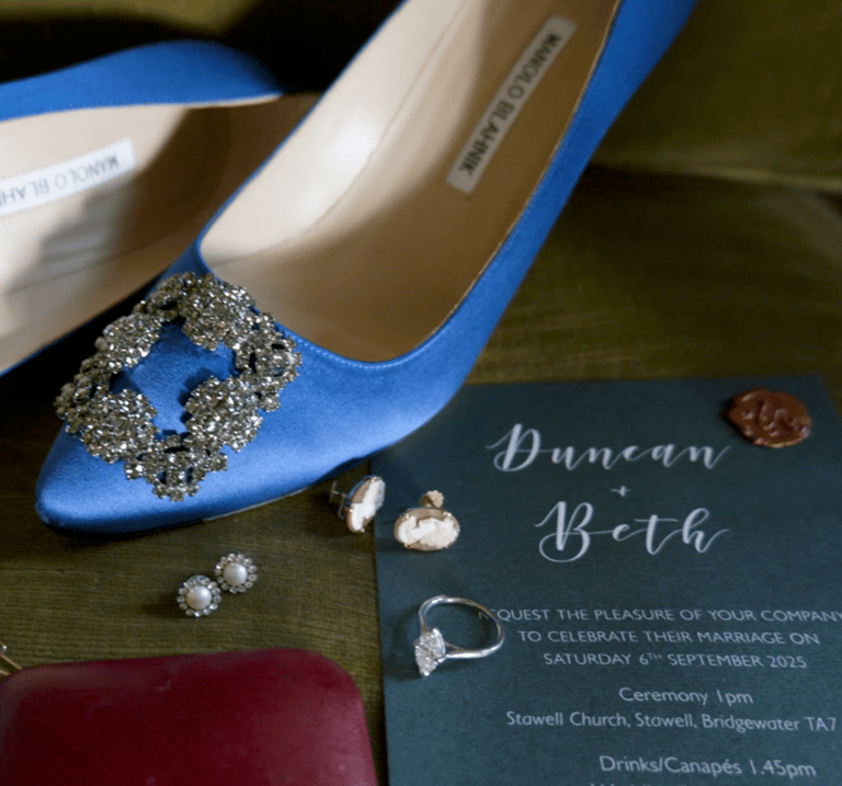 Blue wedding shoes paired with matching accessories, elegantly arranged on a soft surface, showcasing a stylish bridal look.