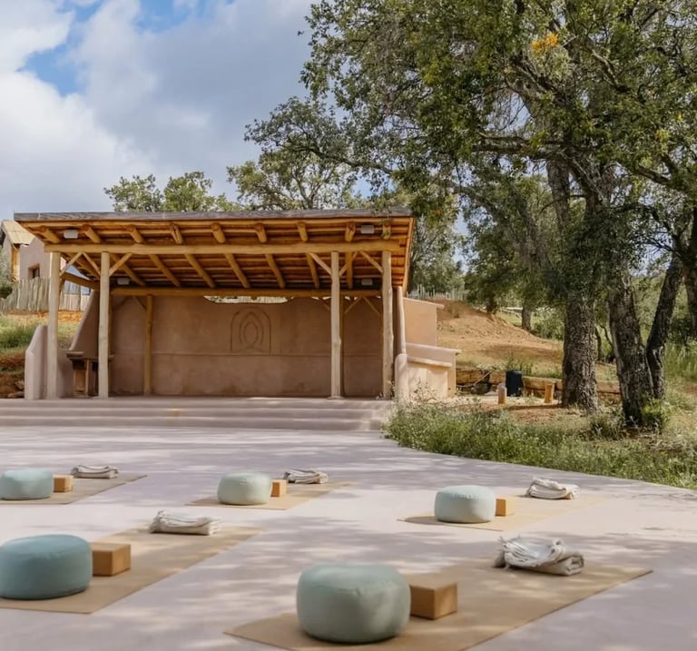 Outdoor yoga shala surrounded by trees and countryside