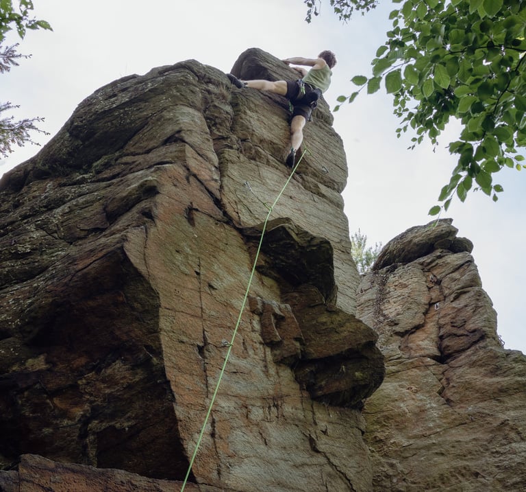 Climbing instructor Christoph lead climbs on the rock in Lower Austria