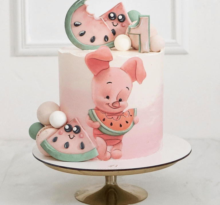 a cake with a piggy and a watermelon