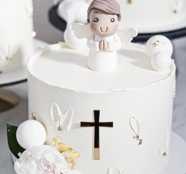 a cake with a little angel on top of it