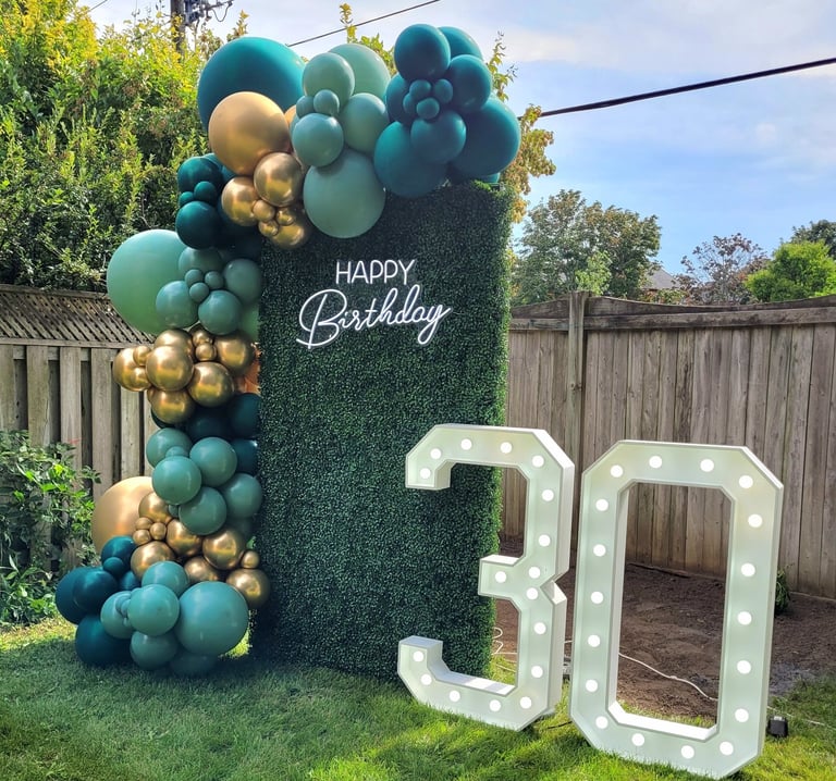 30th marquee with green & gold balloons