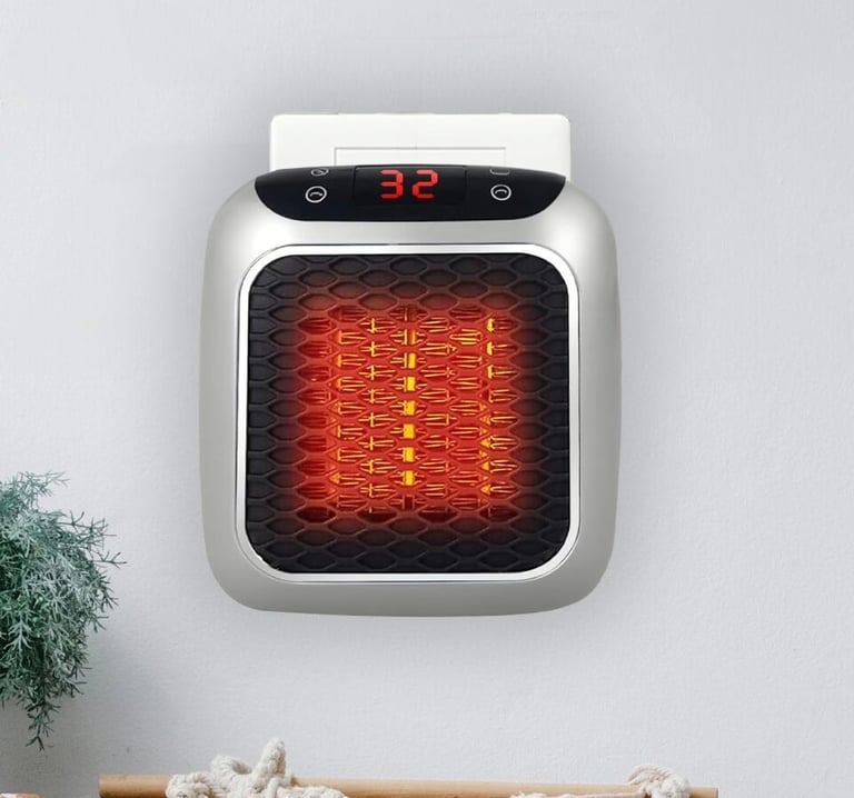 Compact WellHeater plugged into a wall socket, showing a 32°C digital display and glowing heating el