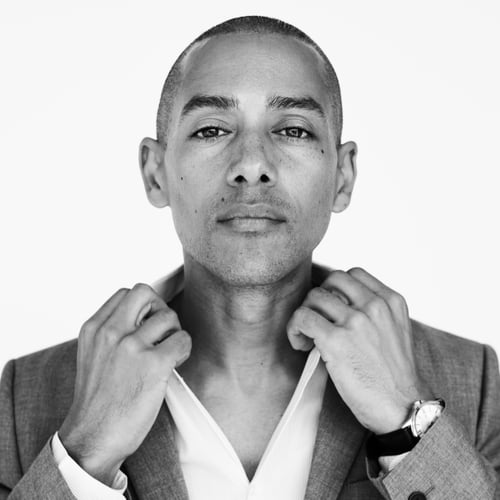 a man in a suit jacket and a watch