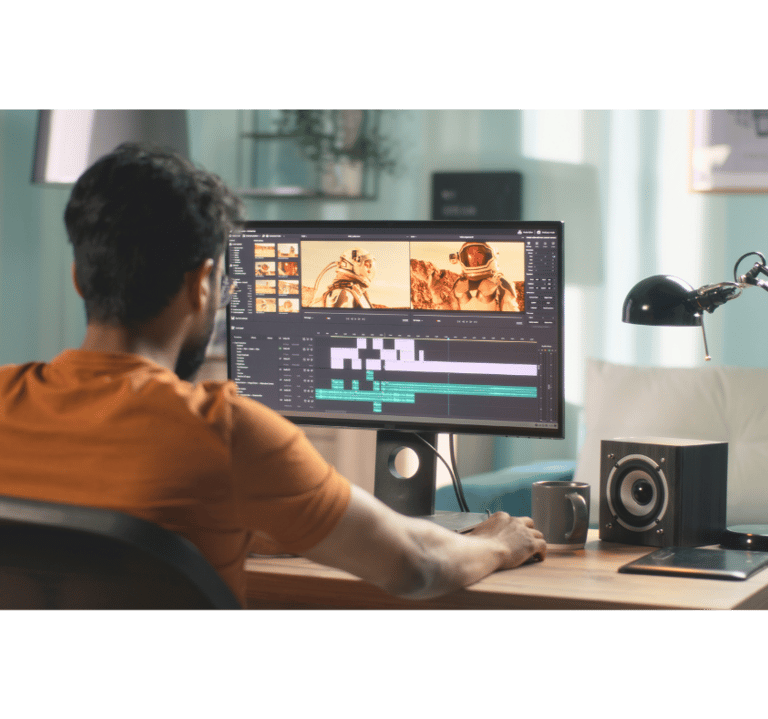 Male video editor focused on editing video content at his workstation
