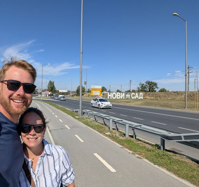 Moose and bugs takes a selfie near the large Novi Sad city sign along a highway in Serbia.
