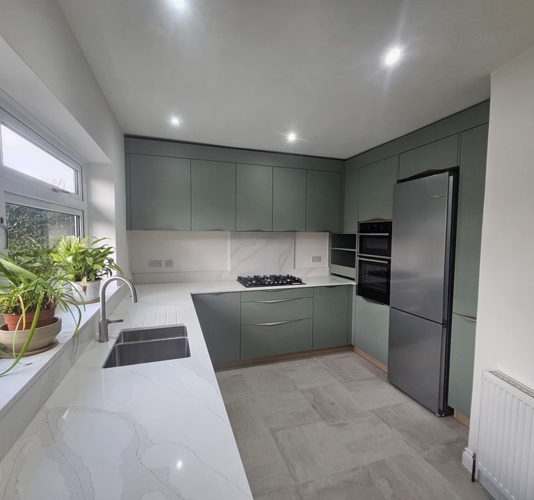 a kitchen with a large window and a potted plant