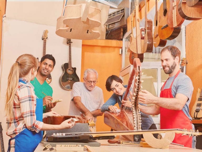 SWB Global Academy Nurturing Curious Minds Individualized Learning | Students learning with a luthier