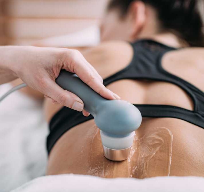Woman receiving ultrasound physiotherapy on her back