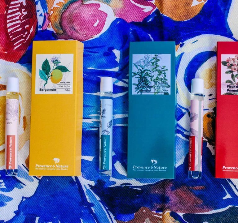 a variety of different colored rollerball perfumes on a colorful tablecloth