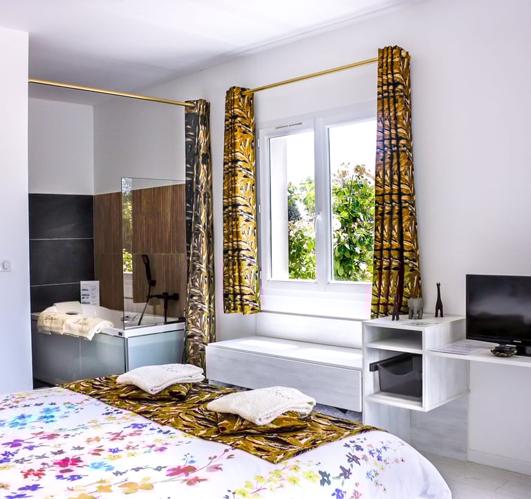 Bedroom with bathroom and toilet, television, air conditioner and pool view at Domaine Des Lucques