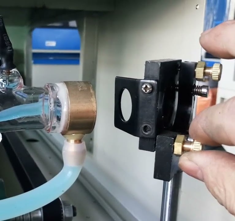 a person holding a bottle of water in a machine