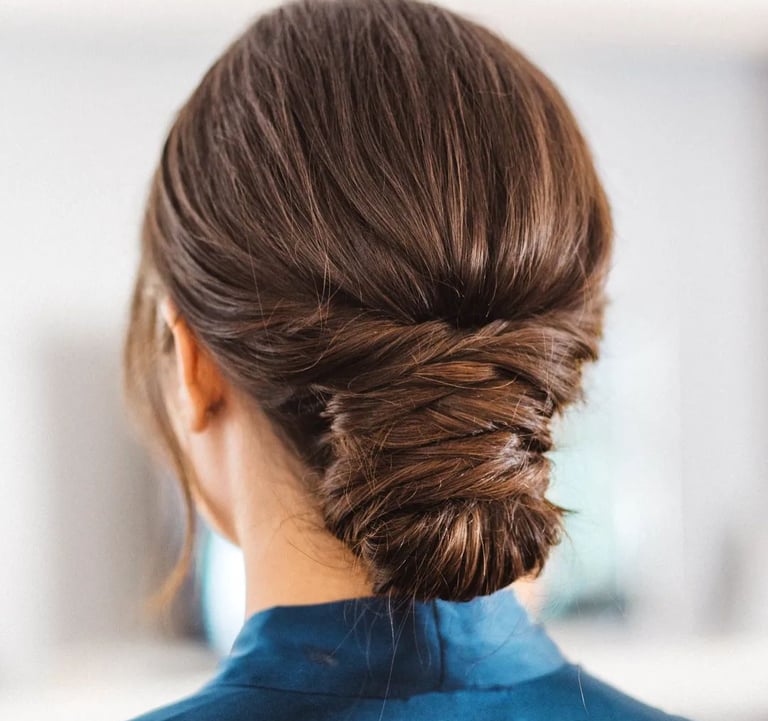 A bride wearing her hair in a low effortless bun with twists