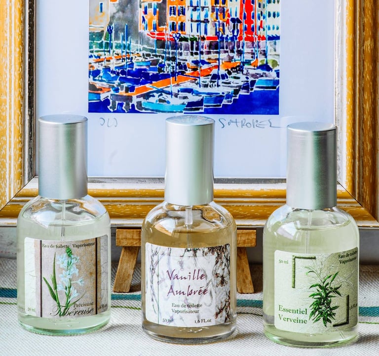 a variety of different scent fragrances and a framed picture of ships in the background