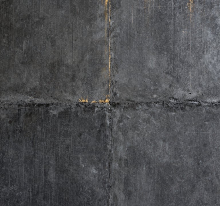 Detail photography of a textured charcoal concrete wall with a subtle golden metallic inlay, high contrast, architectural precision, North American / International setting, soft editorial lighting.